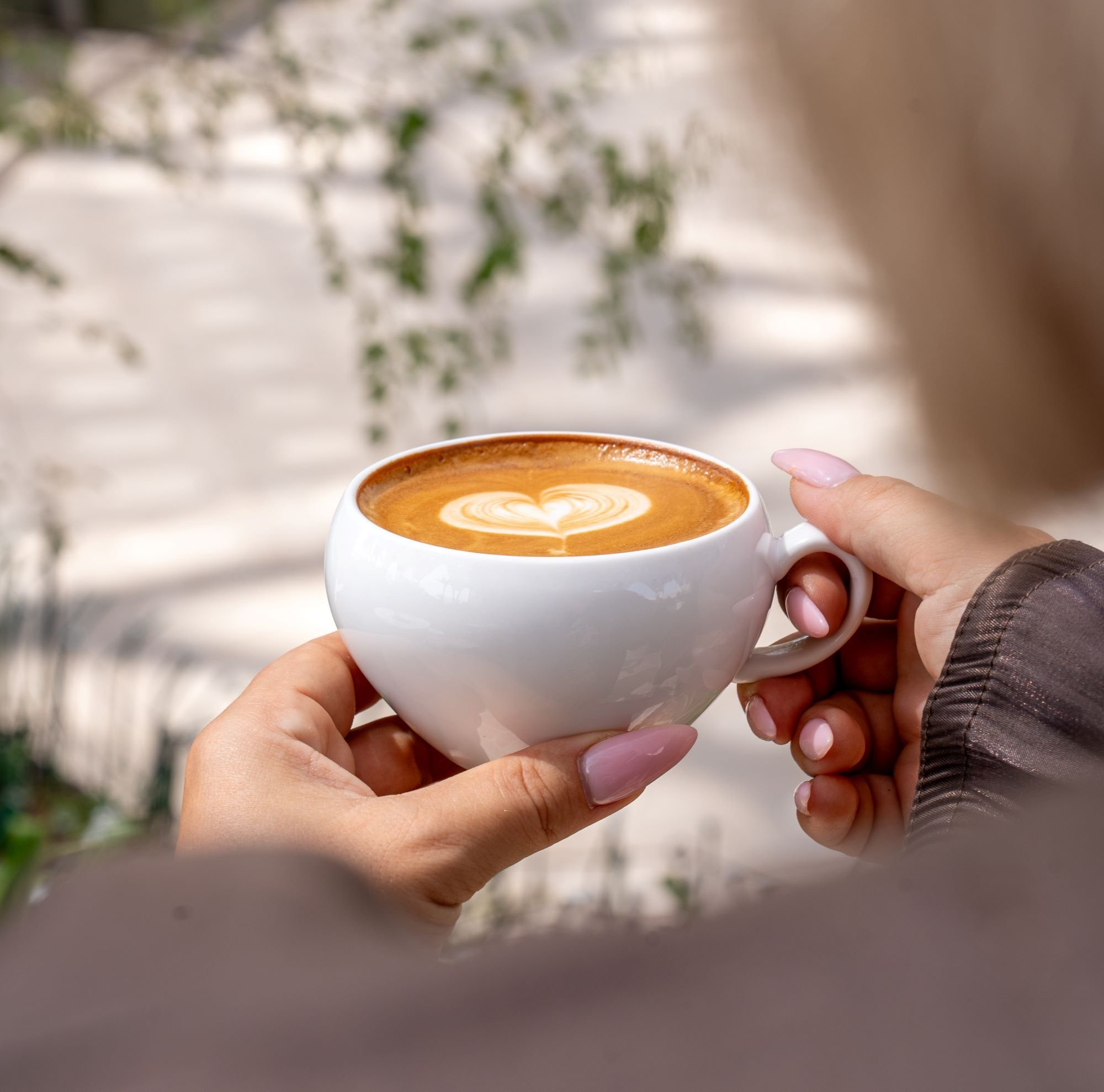Hand holding coffee cup