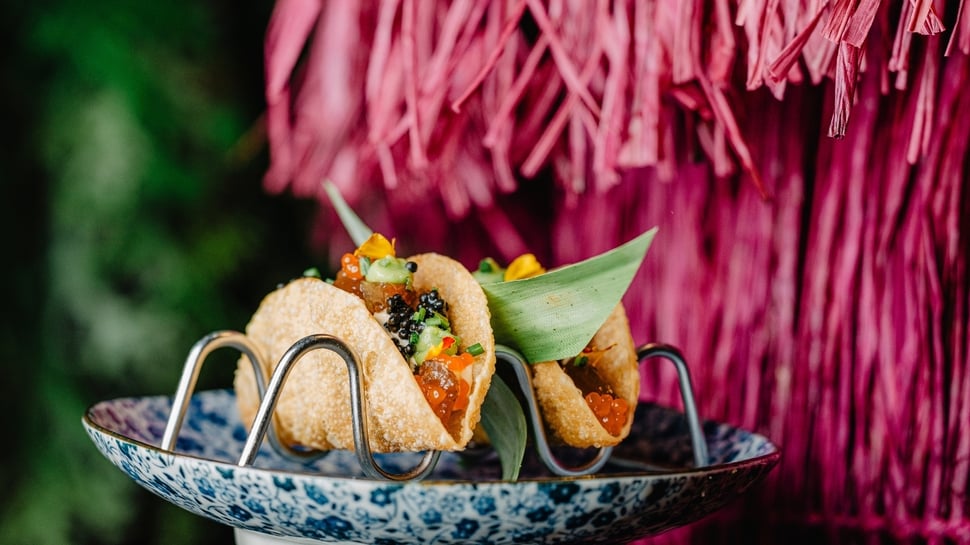 Gourmet tacos with caviar and fresh garnishes, showcasing culinary innovation