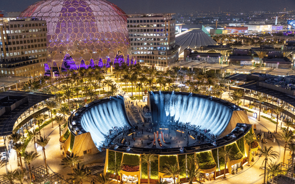 Surreal water feature at Expo City Dubai with visitors enjoying nighttime attractions