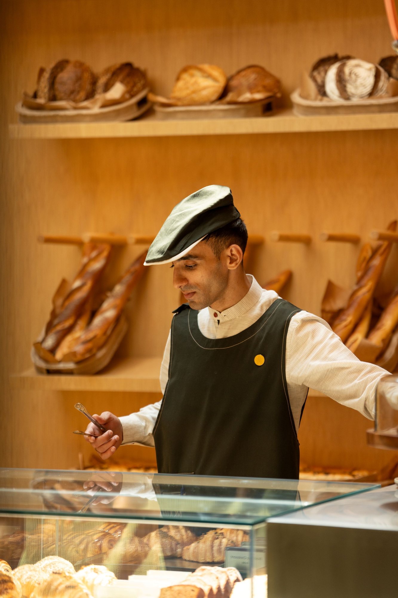 Server behind counter at a bakery