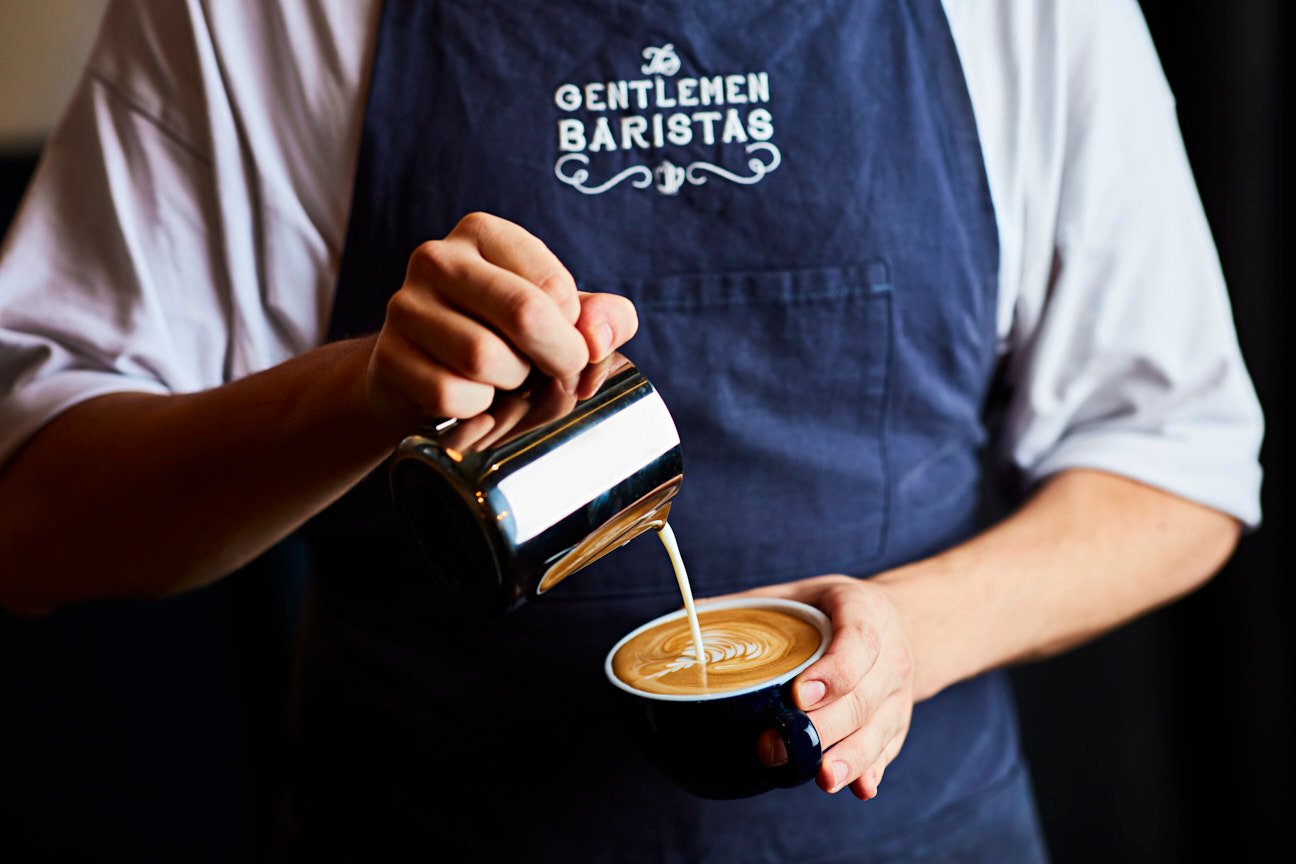 barista pouring coffee