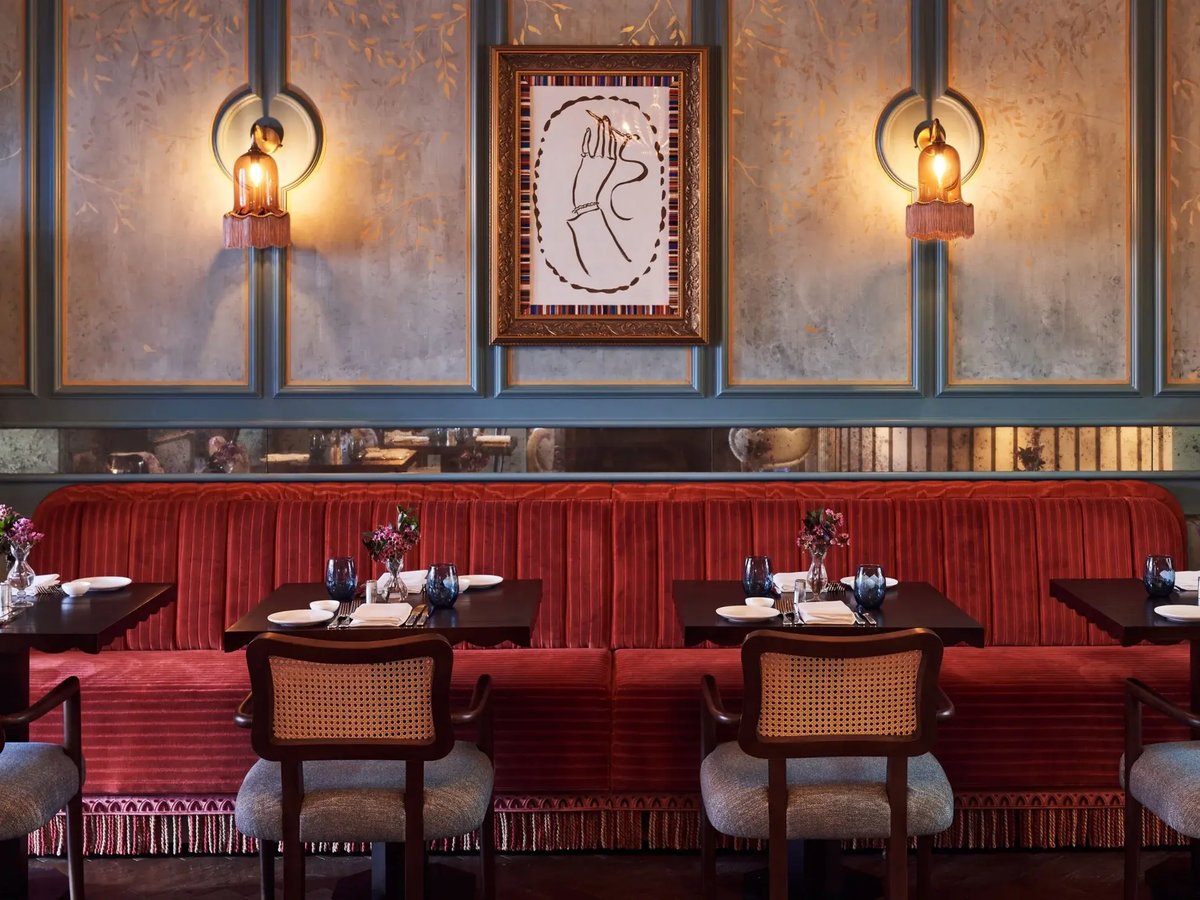 Interior of a restaurant with red booths and chairs