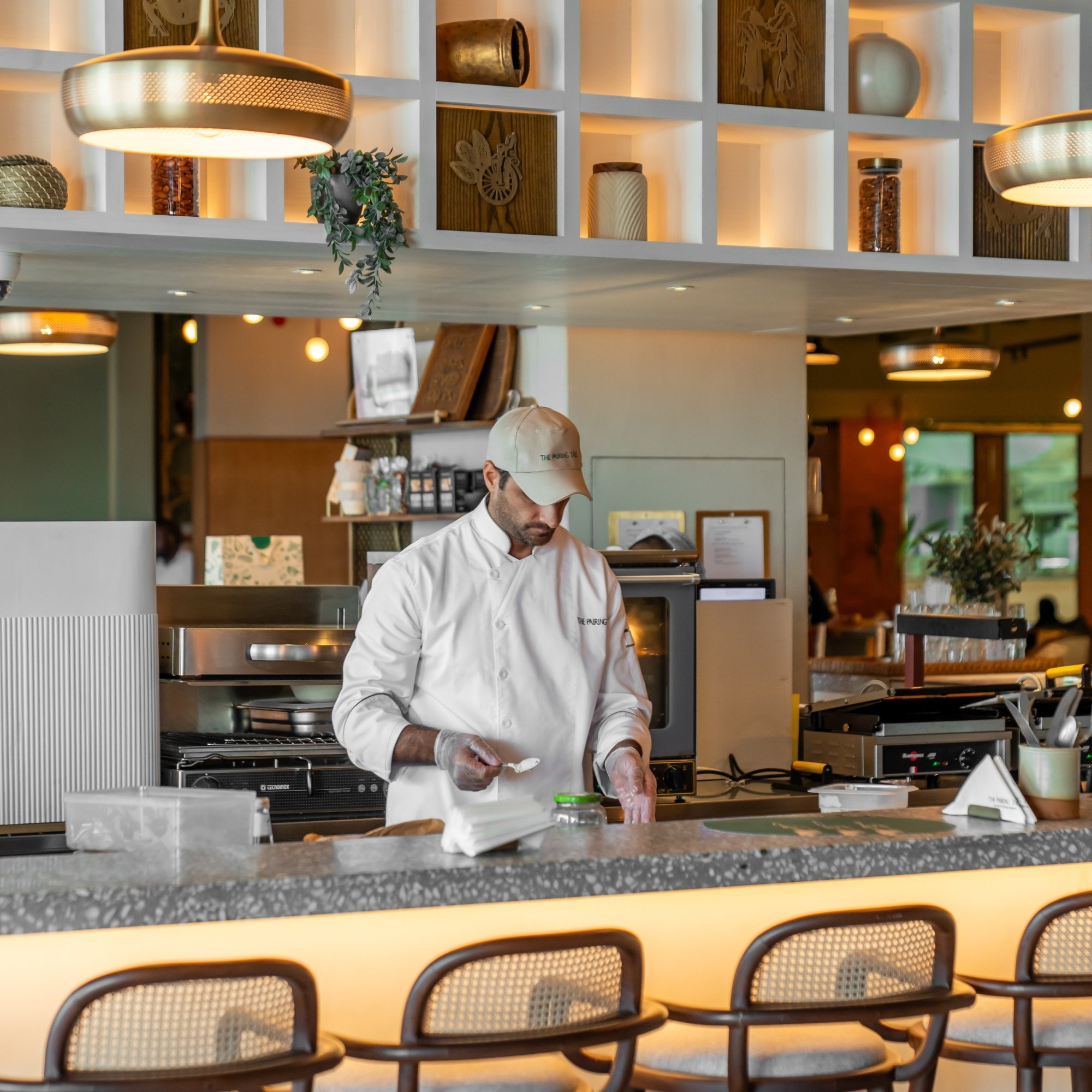 chef-preparing-dish-food-hall-live-kitchen-tgp-international.jpg-1 chef-preparing-dish-food-hall-live-kitchen-tgp-international.jpg-1