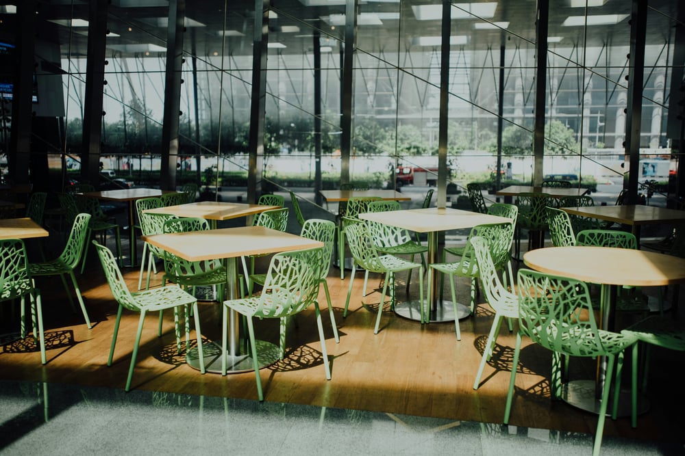 cafe in airport interior with green chairs