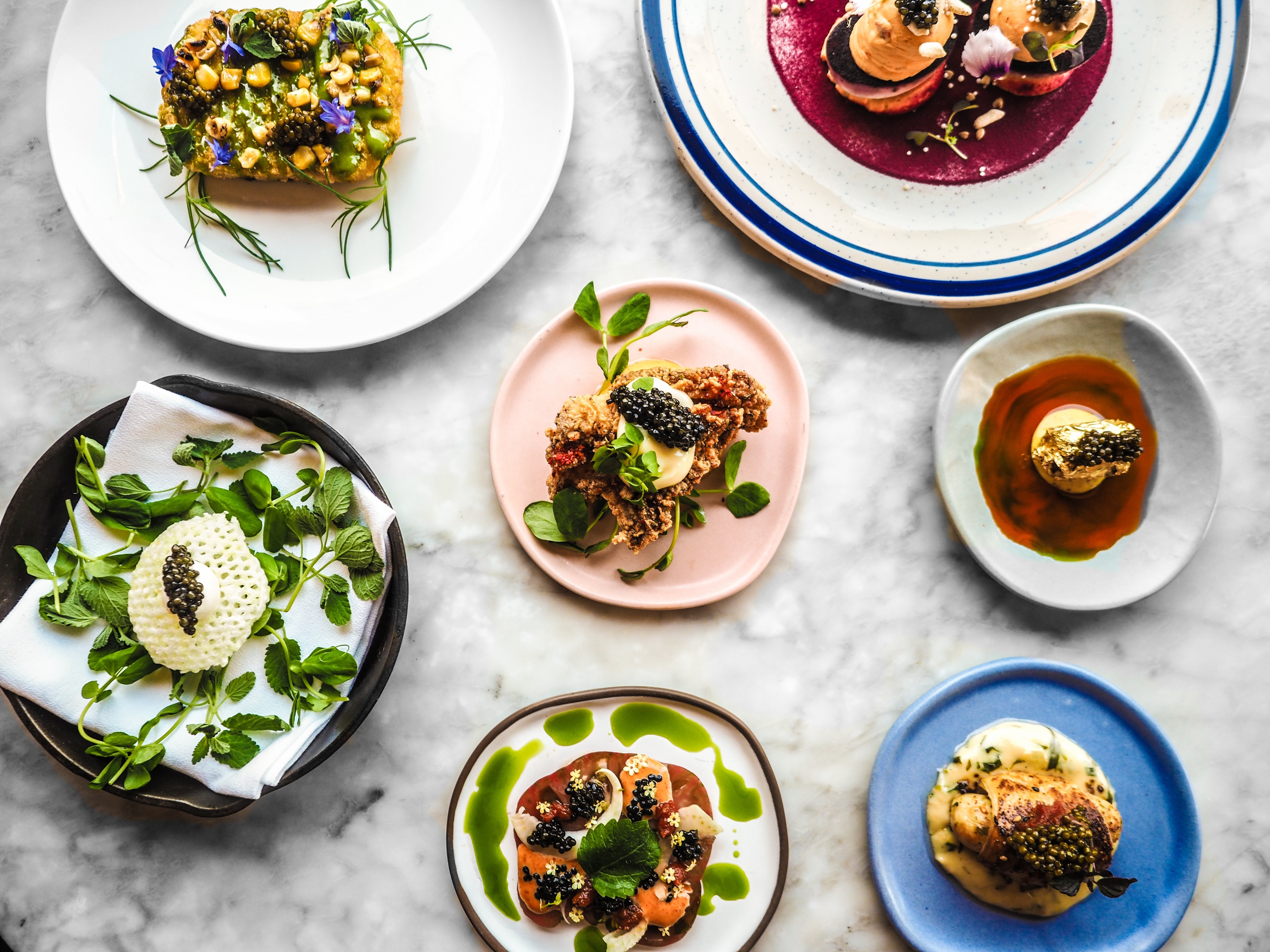 dishes-with-golden-caviar-top-different-plates