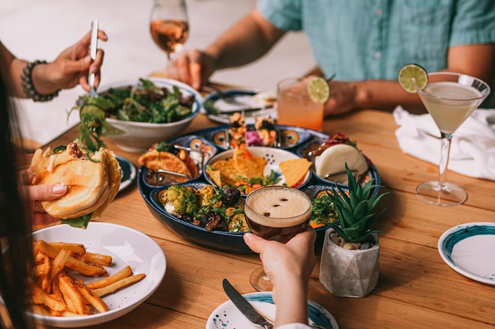 tgp-international-social-dining-table-sharing-food-drinks.jpg