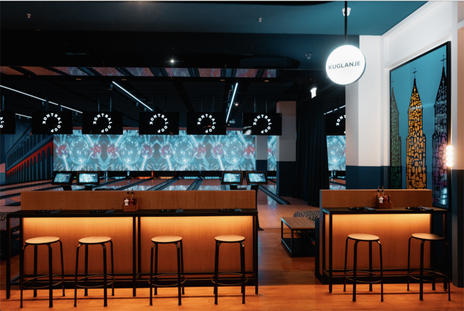 bar stools looking over a bowling alley