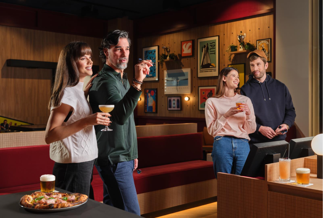 people playing darts and eating, drinking