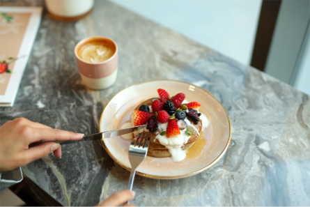 fruit pancakes and coffee in cafe